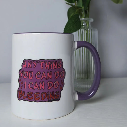 White mug with lilac handle printed with Anything you can do I can do bleeding
